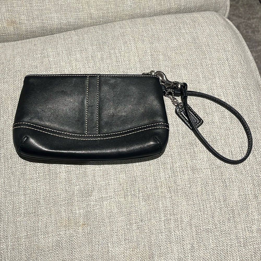 Black leather coach clutch.